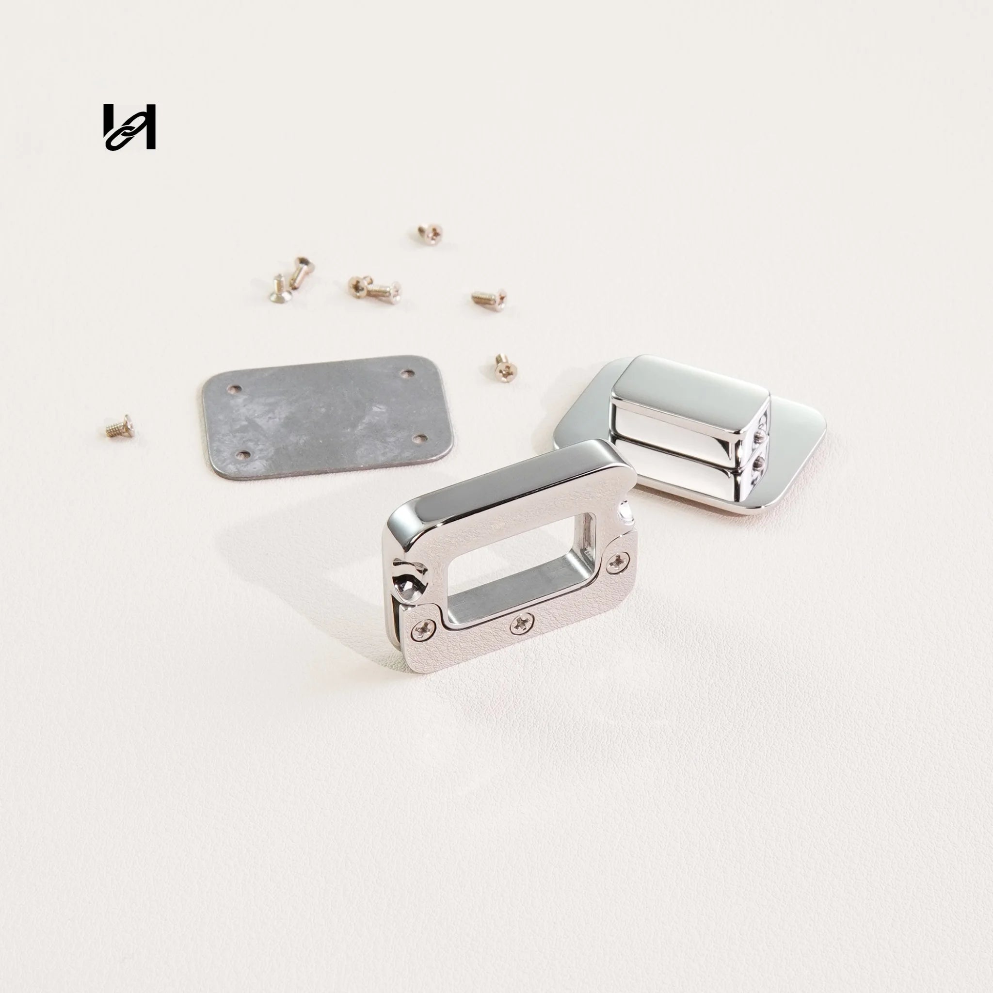 Metallic hardware components on a light gray background