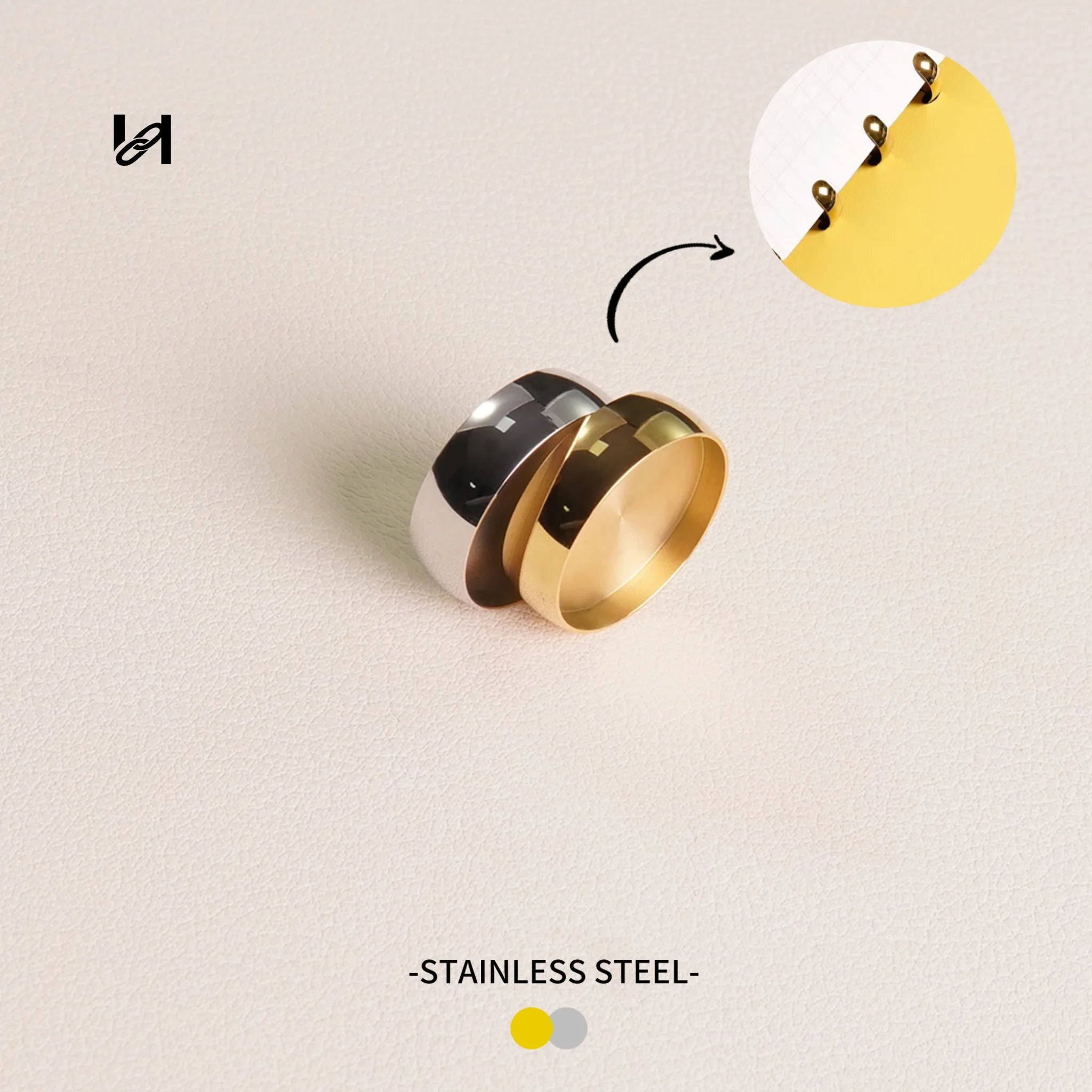 Three rings in different colors on a light beige background with 'Stainless Steel' text.